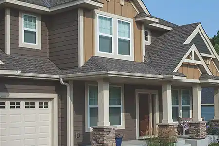 Modern, mid-class home with light brown siding