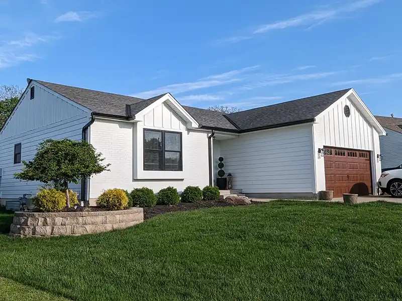 Small, white home with new shingles